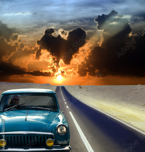Photo: Old car driving on road Old car driving on road