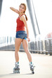 Photo: Beautiful girl rollerskating in morning city Beautiful girl rollerskating in morning city