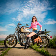 Photo: Biker girl sitting on motorcycle Biker girl sitting on motorcycle