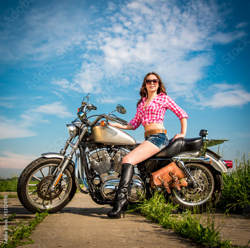 Photo: Biker girl sitting on motorcycle Biker girl sitting on motorcycle