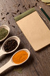 Old notebook, spices in spoons