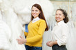 Foto: woman with bride chooses white bridal clothes woman with bride chooses white bridal clothes