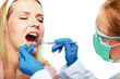 dentist at work on woman patient in office