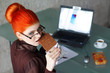 Redhead businesswoman bite chocolate