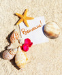blank paper on white sand beach