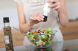 Woman preparing a salad at home