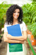 Beautiful female gardener in a greenhouse