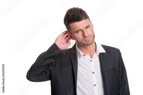 Photo: Puzzled modern business man - isolated on white Puzzled modern business man - isolated on white
