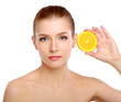 Young brunette woman with oranges in her hands
