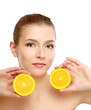 Young brunette woman with oranges in her hands