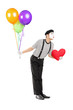Foto: Young mime artist with balloons and red heart giving kisses Young mime artist with balloons and red heart giving kisses