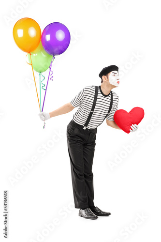 Photo: Young mime artist with balloons and red heart giving kisses Young mime artist with balloons and red heart giving kisses