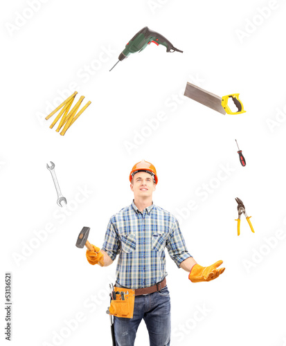 Photo: Manual worker juggling with tools Manual worker juggling with tools