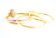 Jewellery ring and golden bracelet on white background