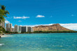 Waikiki beach with azure water in Hawaii with Diamond Head in ba