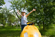 Happy child on lawn mower