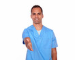 Attractive nurse gesturing a greeting with hand