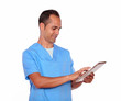 Foto: Young man in nurse uniform using tablet pc Young man in nurse uniform using tablet pc