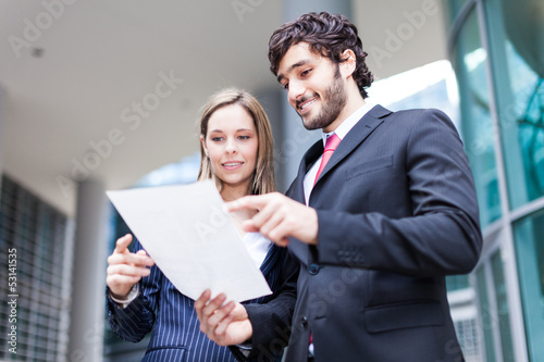 Photo: Business people reading a document Business people reading a document