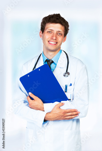 Photo: Portrait of the smiling doctor in interior Portrait of the smiling doctor in interior