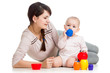 kid girl and mother playing together with cup toys