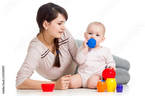 Photo: kid girl and mother playing together with cup toys kid girl and mother playing together with cup toys