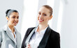 Two attractive business women smiling
