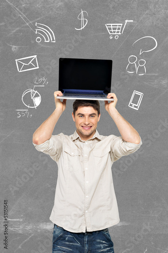Photo: man with laptop and icons around computer man with laptop and icons around computer