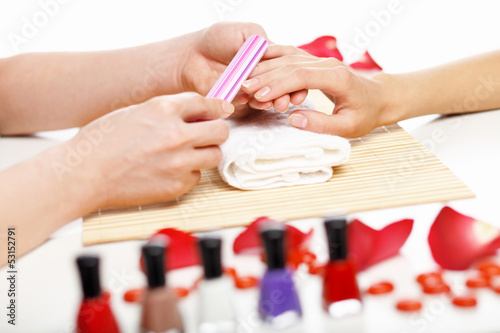 Photo: Woman is getting manicure Woman is getting manicure