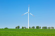 Foto: Wind turbine over blue sky on the summer field Wind turbine over blue sky on the summer field