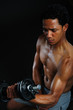 black athlete lifting weight. Male athlete performing biceps