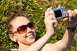 woman in glasses in outdoor taking a picture of themselves