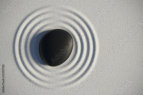 Photo: Zen garden in a top view with a stone and his harmony waves Zen garden in a top view with a stone and his harmony waves