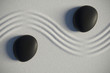 Zen garden in a top view with stones separated by a wave