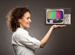 Photo: woman holding a television woman holding a television