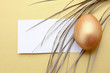 A golden egg, isolated on yellow background