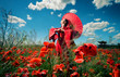 Woman in red clothes with chinese umbrella in the poppy field