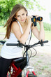 Photo: woman on bicycle with binoculars woman on bicycle with binoculars