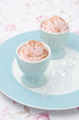 two dessert of whipped cream topped with grated chocolate