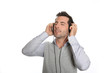 Photo: Man relaxing with headset and music player Man relaxing with headset and music player