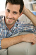 Portrait of handsome guy relaxing at home