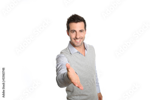 Photo: Closeup of man giving hand for handshake Closeup of man giving hand for handshake