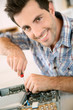 Man fixing electronic appliance