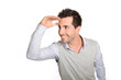 Man looking away wiuth hand on forehead