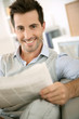 Photo: Man at home reading newspaper Man at home reading newspaper