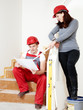 Young worker fixing up a house, discussing in a building lot