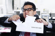 Photo: Angry businessman tear paper at office Angry businessman tear paper at office