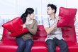 Photo: Angry couple on red sofa at apartment Angry couple on red sofa at apartment