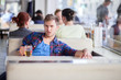 Drunk young man drinking beer in a cafe in the middle of the day