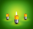 candles into lighting bulbs on green background.Idea concept.
